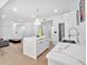 Well-lit kitchen features marble countertops, stainless steel appliances, and a stylish island with seating at 507 Karen Ln, Woodstock, GA 30188
