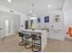 Modern kitchen boasts a waterfall island with seating and white cabinets with marble countertops at 507 Karen Ln, Woodstock, GA 30188