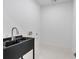 Modern laundry room features a stainless steel sink and sleek fixtures at 507 Karen Ln, Woodstock, GA 30188
