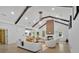 Open-concept living room featuring vaulted ceilings, wood beams, a fireplace, and modern furnishings at 507 Karen Ln, Woodstock, GA 30188