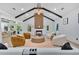Bright living room with vaulted ceilings, wood beams, fireplace, and modern furniture arrangement at 507 Karen Ln, Woodstock, GA 30188
