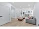 Cozy living room with hardwood floors with grey sofa and direct access to the kitchen at 507 Karen Ln, Woodstock, GA 30188