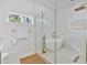 Bathroom featuring a soaking tub, gold hardware, a glass-enclosed shower, and a window at 507 Karen Ln, Woodstock, GA 30188