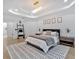 Stylish main bedroom features tray ceiling, recessed lighting, modern rug, and decor at 507 Karen Ln, Woodstock, GA 30188