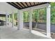 Covered patio with concrete flooring and multiple support columns overlooking the tree-lined yard at 507 Karen Ln, Woodstock, GA 30188