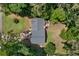 Bird's-eye view of the house showing its roof, lawn, surrounding trees, and driveway at 83 Andrew Jackson Ct, Dallas, GA 30157