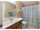 Cozy bathroom featuring a vanity, toilet, and shower with a pretty blue floral curtain at 83 Andrew Jackson Ct, Dallas, GA 30157