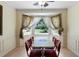 Light-filled dining area features a bay window and unique Coca-Cola-themed table and chairs at 83 Andrew Jackson Ct, Dallas, GA 30157