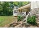 Charming home featuring a welcoming stone porch and a picturesque bay window, surrounded by lush greenery at 83 Andrew Jackson Ct, Dallas, GA 30157