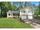 Charming two-story home with stone accents, a welcoming front porch, and a well-maintained lawn at 83 Andrew Jackson Ct, Dallas, GA 30157