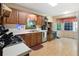 Traditional-style kitchen features wooden cabinets, a stainless steel dishwasher, and natural light from two windows at 83 Andrew Jackson Ct, Dallas, GA 30157