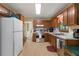 Traditional-style kitchen with wooden cabinets, white appliances, and a stainless steel stove and sink at 83 Andrew Jackson Ct, Dallas, GA 30157