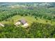 Aerial view of the home with a circular driveway and lush surrounding greenery, showcasing a grand estate at 1101 N Flat Rock Rd, Douglasville, GA 30134