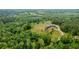 Stunning aerial view of the estate surrounded by lush greenery and mature trees, showcasing property's size at 1101 N Flat Rock Rd, Douglasville, GA 30134