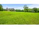 Expansive backyard with lush green grass, mature trees, and a beautiful view of the estate at 1101 N Flat Rock Rd, Douglasville, GA 30134