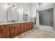 Modern bathroom with a double vanity, granite countertop, and tiled shower at 1101 N Flat Rock Rd, Douglasville, GA 30134
