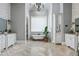 This primary bathroom features double sinks, a soaking tub and a gorgeous chandelier at 1101 N Flat Rock Rd, Douglasville, GA 30134
