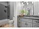 Modern bathroom with gray brick shower, gray vanity cabinet, granite countertop and black hardware at 1101 N Flat Rock Rd, Douglasville, GA 30134