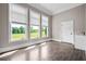 Sunlit bedroom showcasing tile flooring and beautiful backyard views from large windows at 1101 N Flat Rock Rd, Douglasville, GA 30134
