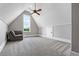 Bright bedroom features a ceiling fan, a window with a view, and a sitting chair at 1101 N Flat Rock Rd, Douglasville, GA 30134