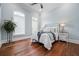 Charming bedroom with light blue walls, decorative windows, wood flooring, and ceiling fan at 1101 N Flat Rock Rd, Douglasville, GA 30134
