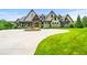 Elegant two-story home with a circular driveway, manicured landscaping and charming stone and wood accents at 1101 N Flat Rock Rd, Douglasville, GA 30134