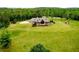 Stately home with stone and brick facade, nestled in a sprawling green lawn, near a wooded area at 1101 N Flat Rock Rd, Douglasville, GA 30134