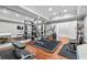 Bright home gym with mirrored walls, workout equipment, and hardwood floors for fitness enthusiasts at 1101 N Flat Rock Rd, Douglasville, GA 30134