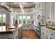Gourmet kitchen with a large island, farm sink, and bright windows overlooking the backyard at 1101 N Flat Rock Rd, Douglasville, GA 30134