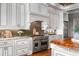 Close-up of a gourmet kitchen showcasing the stainless steel range, custom cabinets, and granite countertops at 1101 N Flat Rock Rd, Douglasville, GA 30134
