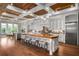 Gourmet kitchen with white cabinets, a large wood-topped island, and stainless steel appliances at 1101 N Flat Rock Rd, Douglasville, GA 30134