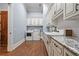 Well-equipped laundry room with granite countertops, custom cabinets, and modern washer and dryer at 1101 N Flat Rock Rd, Douglasville, GA 30134
