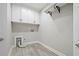 The laundry room features storage cabinets, utility hook and modern gray walls at 1101 N Flat Rock Rd, Douglasville, GA 30134