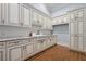 Spacious laundry room with custom cabinets, granite countertops and modern appliances at 1101 N Flat Rock Rd, Douglasville, GA 30134