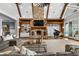 Bright living room with a stone fireplace, a piano, and custom built-in bookshelves at 1101 N Flat Rock Rd, Douglasville, GA 30134