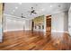 Open living room with hardwood floors, stone fireplace, and built-in bookshelves for cozy living at 1101 N Flat Rock Rd, Douglasville, GA 30134
