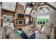 Grand living room featuring a stone fireplace, vaulted ceilings, and expansive windows to the outdoors at 1101 N Flat Rock Rd, Douglasville, GA 30134