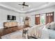 Bright and airy main bedroom with hardwood floors, barn doors, and elegant furnishings at 1101 N Flat Rock Rd, Douglasville, GA 30134