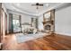 Spacious main bedroom featuring a stone fireplace, tray ceiling, and hardwood floors at 1101 N Flat Rock Rd, Douglasville, GA 30134