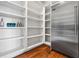 Walk-in pantry featuring a stainless steel fridge and ample shelving for organized storage at 1101 N Flat Rock Rd, Douglasville, GA 30134