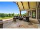 Spacious covered patio with stone flooring, outdoor seating, and a beautiful backyard view at 1101 N Flat Rock Rd, Douglasville, GA 30134