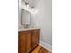 Elegant powder room features a wood vanity with granite countertop and updated fixtures at 1101 N Flat Rock Rd, Douglasville, GA 30134