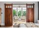 Sitting room with barn door entry featuring two chairs, chandelier, and ample natural light at 1101 N Flat Rock Rd, Douglasville, GA 30134