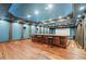 Home theater with bar seating, rich wood accents, and a large projection screen at 1101 N Flat Rock Rd, Douglasville, GA 30134