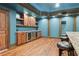 Stylish wet bar area with wooden cabinets, granite countertops, and seating for added convenience at 1101 N Flat Rock Rd, Douglasville, GA 30134