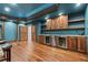 Convenient wet bar with custom cabinets, stainless steel refrigerators, and hardwood floors for relaxation at 1101 N Flat Rock Rd, Douglasville, GA 30134