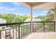 Covered balcony overlooking lush treetops and surrounding neighborhood at 1502 River Green Nw Dr # 1502, Atlanta, GA 30327