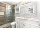 Bathroom features a glass shower, marble countertops, and illuminated mirror at 1502 River Green Nw Dr # 1502, Atlanta, GA 30327