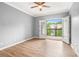 Bedroom with ceiling fan, hardwood floors, and access to balcony with french doors at 1502 River Green Nw Dr # 1502, Atlanta, GA 30327