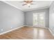 Bedroom with ceiling fan, hardwood floors, and access to balcony with french doors at 1502 River Green Nw Dr # 1502, Atlanta, GA 30327